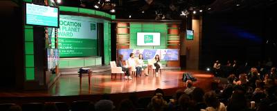 Panelists on a stage at Planet Forward.