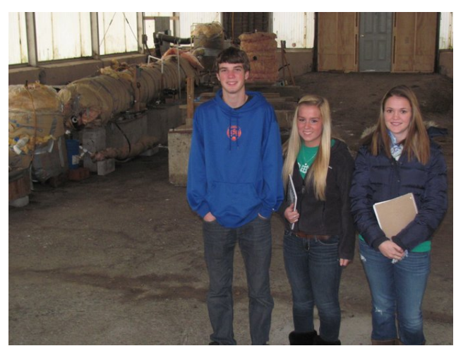 East Syracuse-Minoa seniors, from left, Kyle Scanlon, Danielle Hobb and Mallory Petterelli, stand in front of the anaerobic digester at the village of Minoa Waste Water Treatment Facility