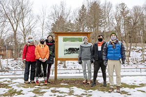 people in front of a forest of food sign