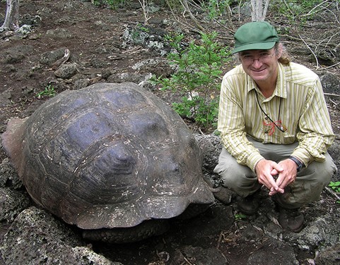 James gibbs next to a giant Galapagos tortoise