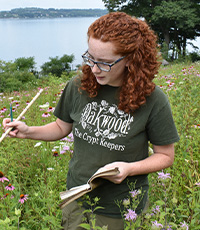 Elise standing in a meadow with flowers