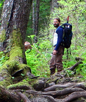 Colin Beier in the woods with a backpack