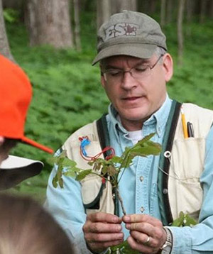 Gregory McGee holding a small plant