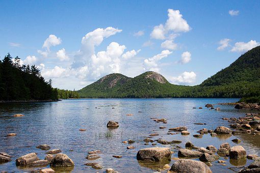 Stream of water and gree hills along the shore