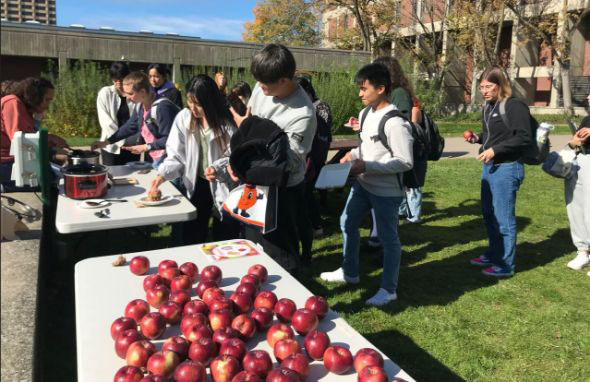 Students getting apples in the Quad
