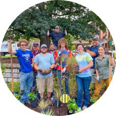 Students planting a pollinator garden located by the Robin Hood Oak