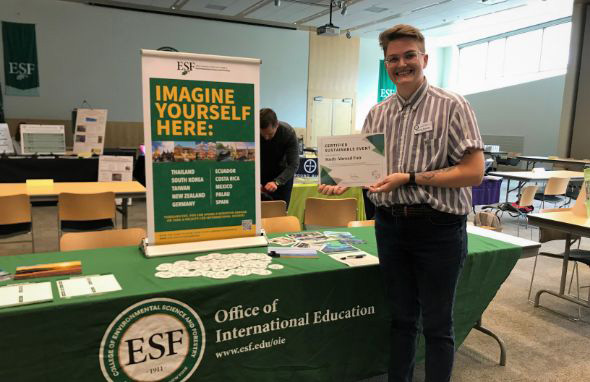 Jules Findlay holding sustainable event certification at Study Abroad Fair