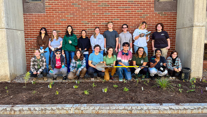 Campus drive planting team posing for a photo with gardening tools