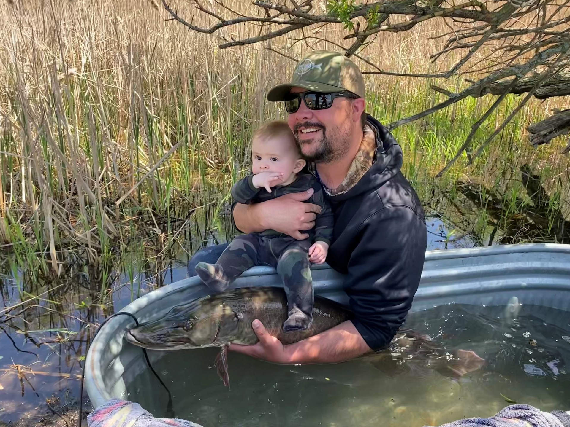 T I B S alumnae Colby Bowman holds Callen, who came to visit research crews near the Robert Moses saunder Power Dam in Massena, N Y