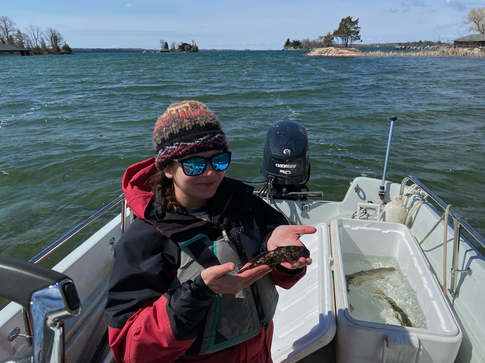 Anna Conklyn on a boat holding a field goby