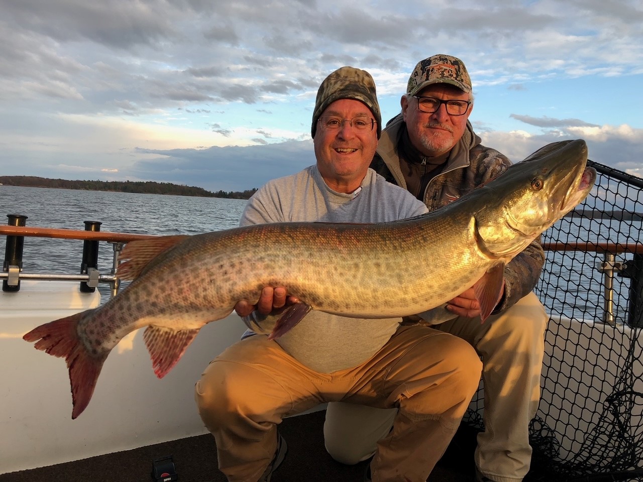 Andy Skop and a colleague holding an adult muskellunge