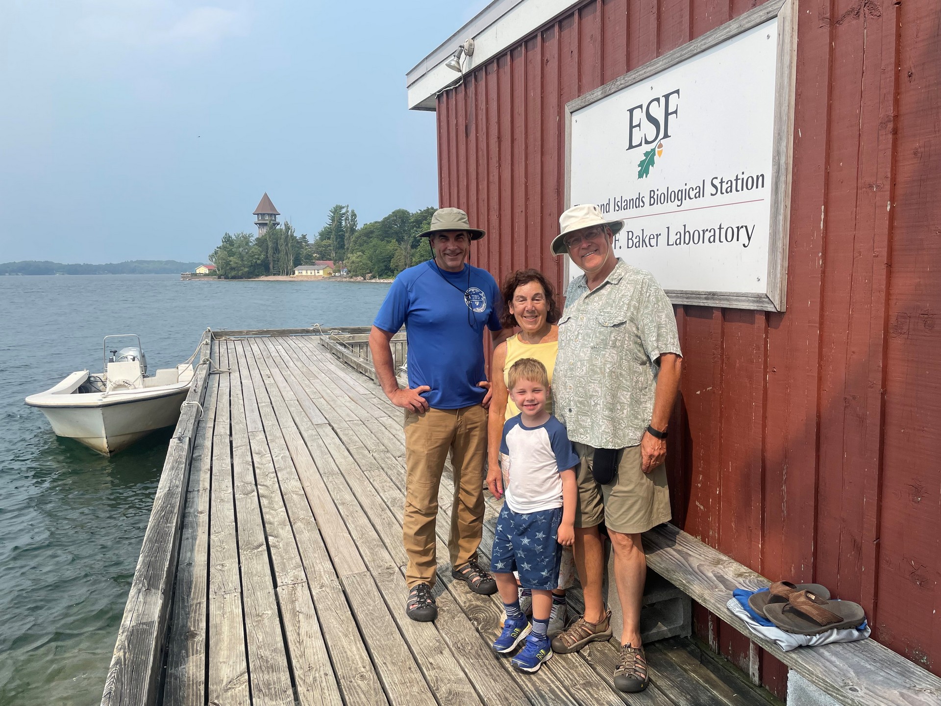 Nels, Debbi, and their grandson Logan on a visit to T I B S get a group photo with John Farrell