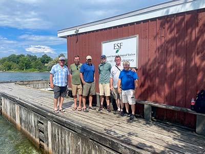 musky citizen science anglers infront of boathouse