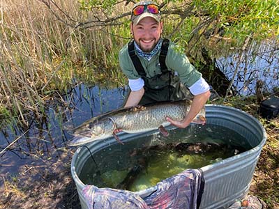 E S F student Jack Marshall holding an adult muskie