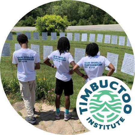 Three students looking at signs and the Timbuctoo Institute logo.