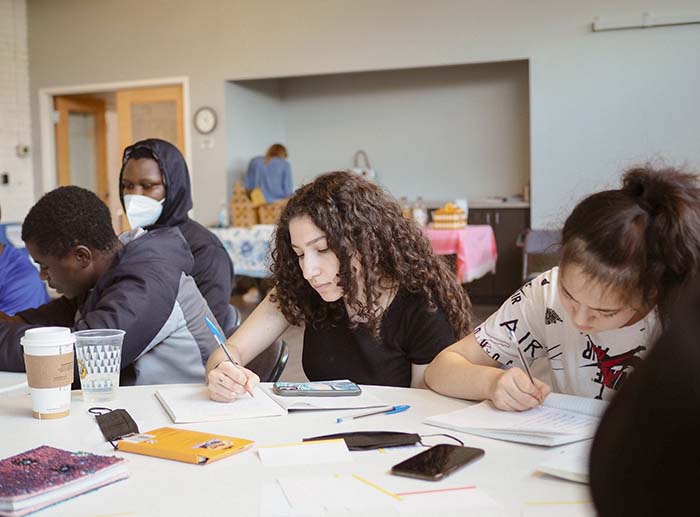 Middle and high school aged students are writing in their journals as part of the Write Out program.