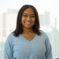 Amaya Densen smiling. She is wearing a light blue top