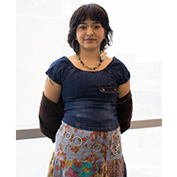 Eden Torales in a blue top and pattern skirt
