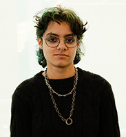 Rowan Vazquez wearing glasses and a black shirt