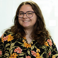 Sof Harrison wearing glasses and a flower pattern shirt
